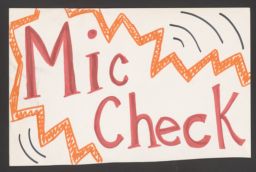 Poster board sign that says "Mic Check"